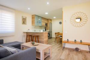 a living room with a couch and a table at Apartamentos La Cortina in Cangas de Onís