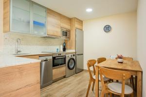 A kitchen or kitchenette at Apartamentos La Cortina