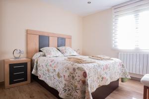 A bed or beds in a room at Apartamentos La Cortina