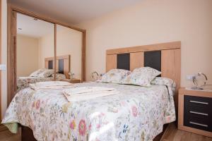 A bed or beds in a room at Apartamentos La Cortina