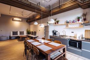 a kitchen with a wooden table and a dining room at Lainandao Villa in Hengchun