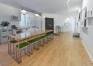 a kitchen with a table and some green chairs at Madridcito in Madrid