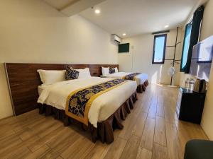 Postelja oz. postelje v sobi nastanitve Penghu Dayou View B&B