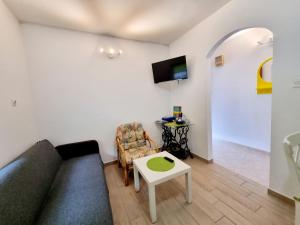a living room with a couch and a table at ARA-ZAROK in Baška