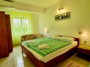a bedroom with a large bed and a chair at ARA-ZAROK in Baška +19 photos