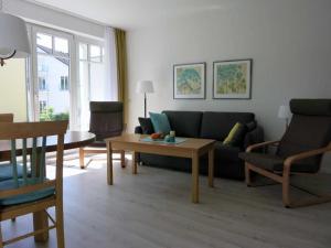 a living room with a couch and a table at Villa Granitz - Ferienwohnung Rechtern in Göhren