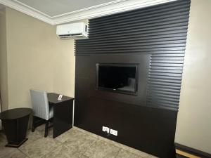 A television and/or entertainment centre at Msquare Hotel GRA