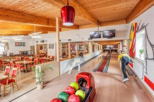two people playing bowling in a bowling alley at Wellness & Restaurant U Fandy in Lhotka