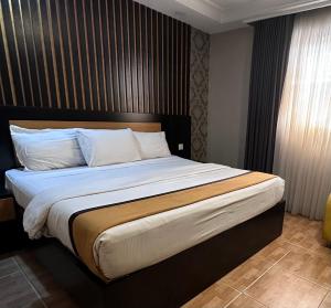 A bed or beds in a room at Msquare Hotel GRA