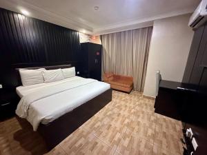 A bed or beds in a room at Msquare Hotel GRA