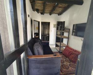 een woonkamer met een bank en een tv bij 2 Bed Chalet - Yasam Cloud Nine And a Half Hunza in Baltit