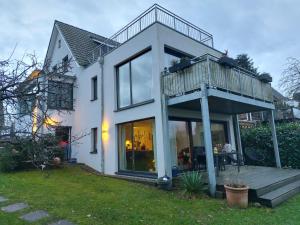 uma casa com uma varanda e um deque em Residenz am Trammer See em Plön