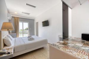 a hotel room with a bed and a television at Astron Hotel Rhodes in Rhodes Town
