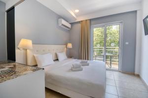 Postel nebo postele na pokoji v ubytování Astron Hotel Rhodes