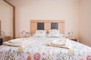 A bed or beds in a room at Apartamentos La Cortina