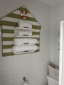 a pile of towels in a bathroom with a mirror at Coastal Joy - Room 1 in Newbiggin-by-the-Sea