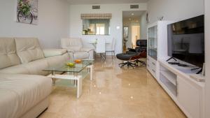 a living room with a couch and a table at Duquesa Village 7,19,12 in Manilva