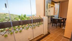 a balcony with a table and a view of the ocean at Duquesa Village 7,19,12 in Manilva