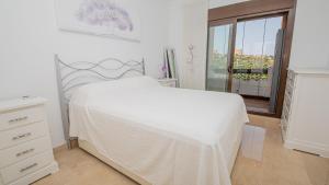 a white bedroom with a white bed and a window at Duquesa Village 7,19,12 in Manilva +17 photos