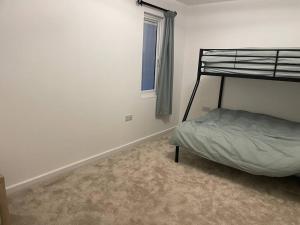 a bedroom with a bunk bed and a window at Poplar holiday cottage in Moulton Chapel