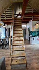 a wooden staircase in the middle of a room at Leśny Zakątek agroturystyka z głaskaniem zwierząt in Ożarów +33 photos