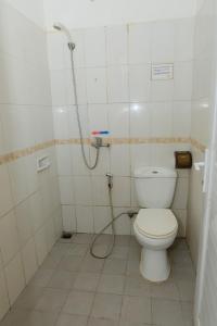 a bathroom with a toilet and a shower at The Kirana Purnama Semarang in Semarang