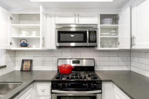 a kitchen with a stove top oven with a microwave at Beverly Grove 2BR nr Cedar Sinai Hospital LAX-124 in Los Angeles