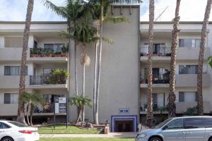 a building with palm trees in front of it at Beverly Grove 2BR nr Cedar Sinai Hospital LAX-124 in Los Angeles