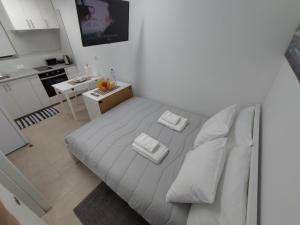 a bedroom with a white bed with two towels on it at Room Dream Beato in Lisbon