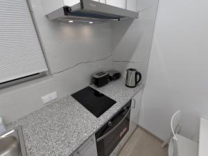 a small kitchen with a sink and a stove at Room Dream Beato in Lisbon