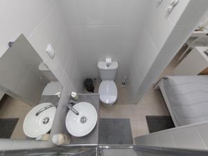 a white bathroom with a toilet and a sink at Room Dream Beato in Lisbon