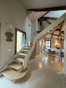 a staircase in a house with a glass railing at Palazzo Veneziano direct at the canal with roof terrace in Venice