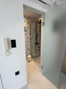 a bathroom with a walk in shower in a room at Seaview by Agora Flats in Thessaloniki
