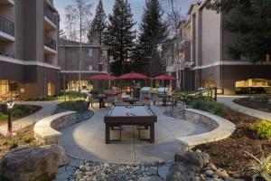 a patio with tables and benches in a building at Walnut Creek 1BR w BBQ Gym WD nr BART SFO-987 in Pleasant Hill