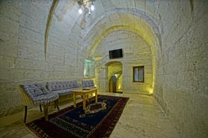 a room with a couch and a table in a building at Cappa Cave Hotel in Göreme