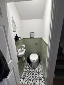 a bathroom with a toilet and a sink at Beautiful house on the River Itchen in Winchester