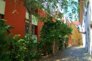 an alley in a city with red and yellow buildings at Buda Castle Apartments in Budapest