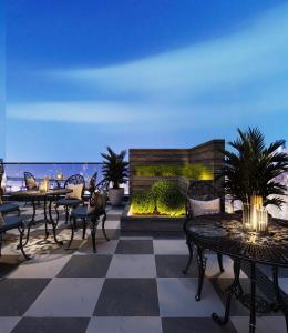 a patio with tables and chairs and a view of the ocean at Annova Nha Trang Hotel in Nha Trang