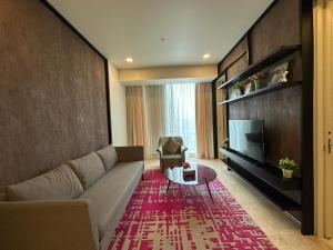 a living room with a couch and a television at Tropicana The Residence KLCC By Rainbow Suites in Kuala Lumpur