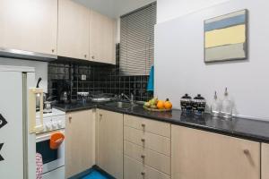 a kitchen with a sink and a counter top at Modern flat in city center in Athens