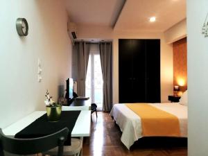 a hotel room with a bed and a desk and a window at Modern flat in city center in Athens