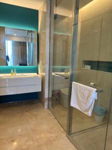 a bathroom with a shower and a sink and a toilet at Tropicana The Residence KLCC By Rainbow Suites in Kuala Lumpur