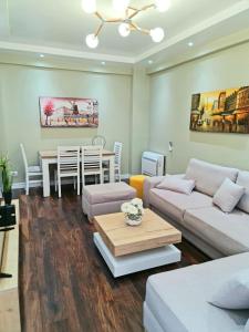 - un salon avec un canapé et une table dans l'établissement Luxury Residence Apartment, à Tirana