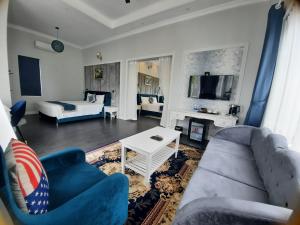 a living room with a couch and a tv at Vườn Vua Resort & Villas in Phú Thọ