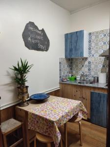 a kitchen with a table with a table cloth on it at Hostal la Fruta Nueva apertura in Avilés