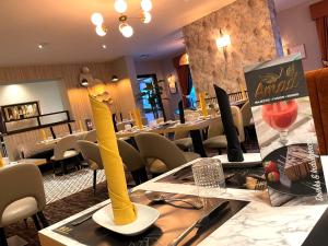 a restaurant with a table with a yellow vase on it at The Continental Hotel, Derby in Derby