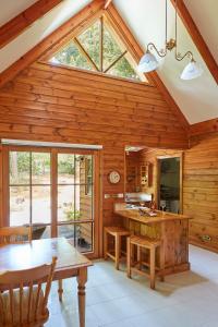 a kitchen with wooden walls and a large window at Fernhem Cottages- Love in the Mist in Emerald