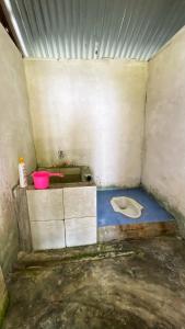 a dirty bathroom with a toilet and a sink at Tanjung Mefiyai Homestay in Fam