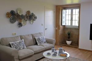 a living room with a couch and a table at Casa de Valente - Camariñas in Camariñas