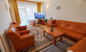 a living room with a couch and a table at Pensiunea Eden in Sovata